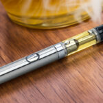 clogged vape blog post header, vape pen on table